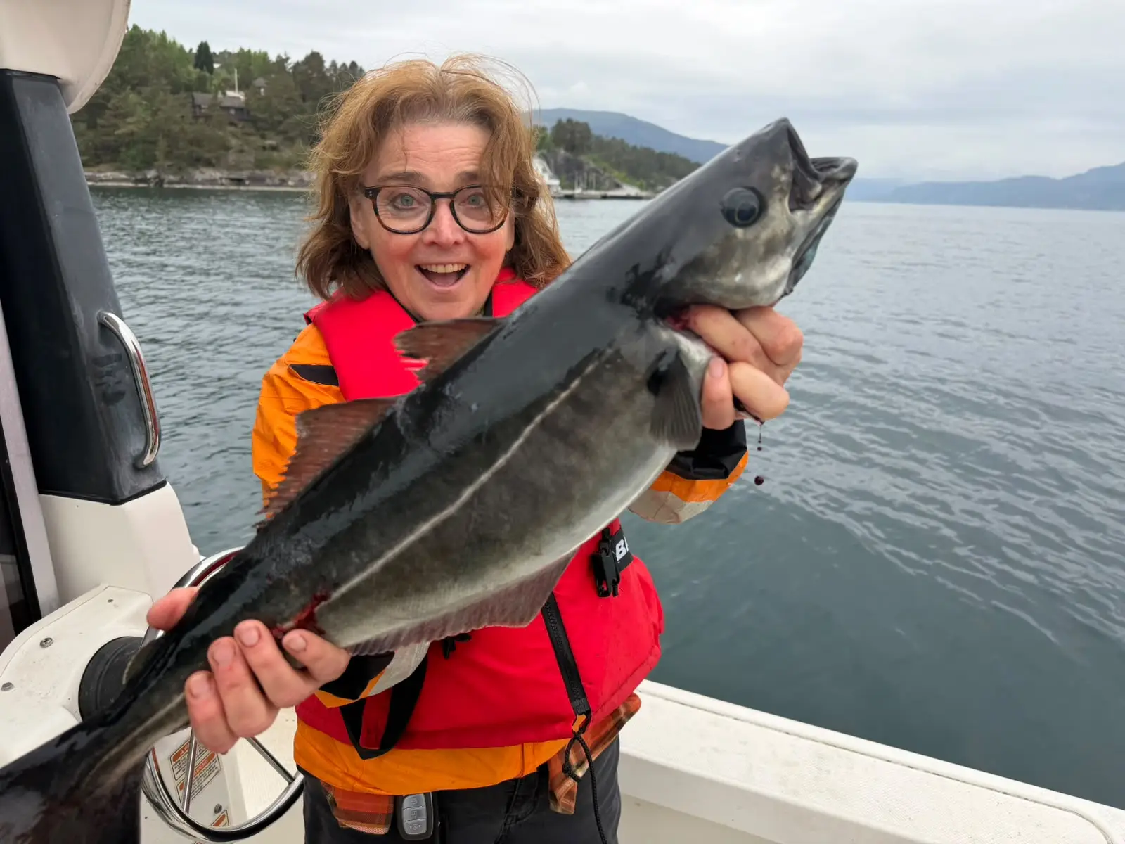Woman holding a big fish in her hand